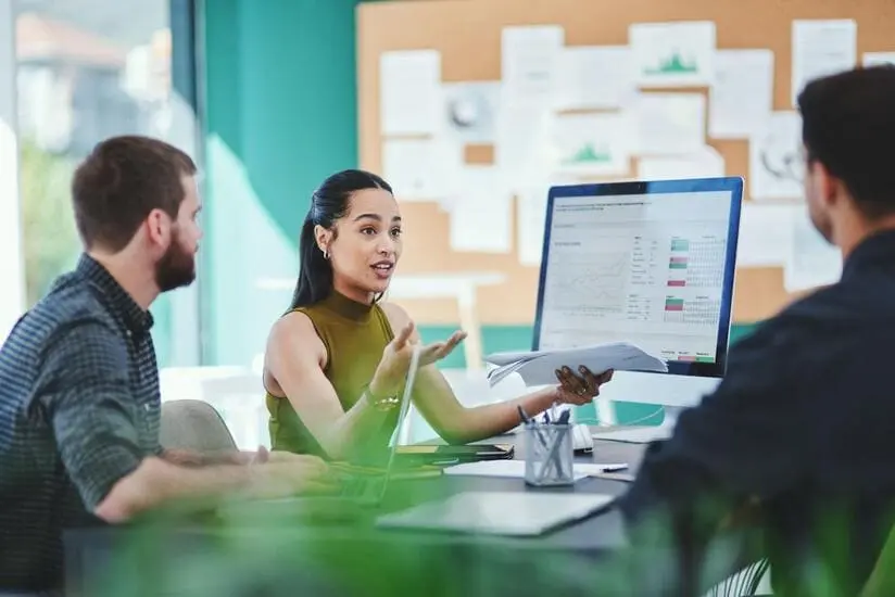 Team discussing campaign and content plans in a modern office meeting, representing ambitious brands and growing businesses planning marketing activity.